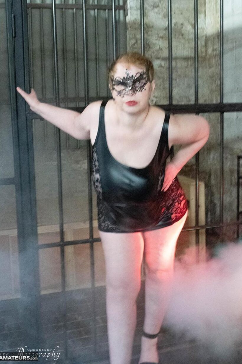 Posh Sophia poses in fetish outfits inside and outside a jail cell (shot 7)