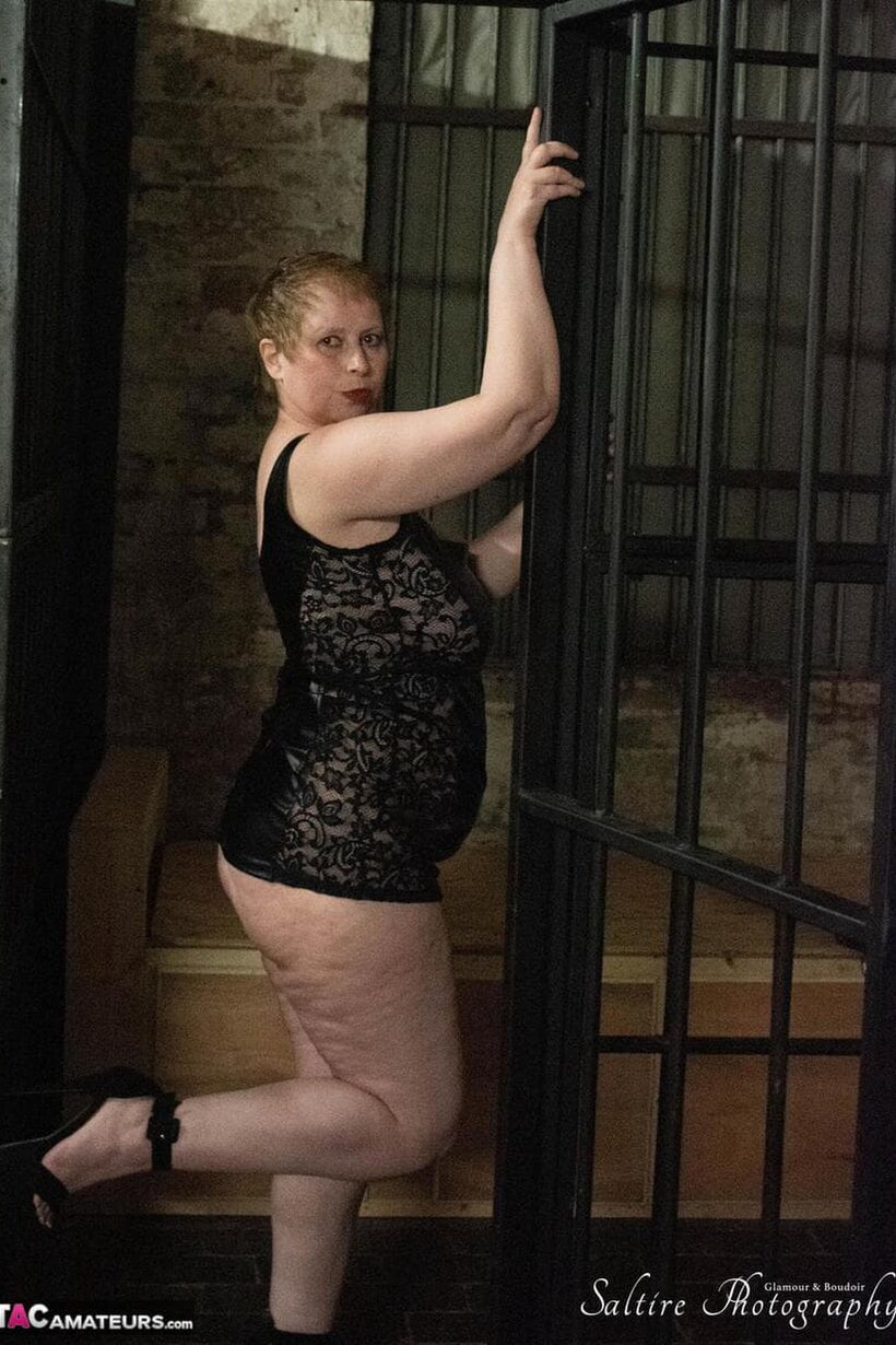 Posh Sophia poses in fetish outfits inside and outside a jail cell, photo 15 of 16