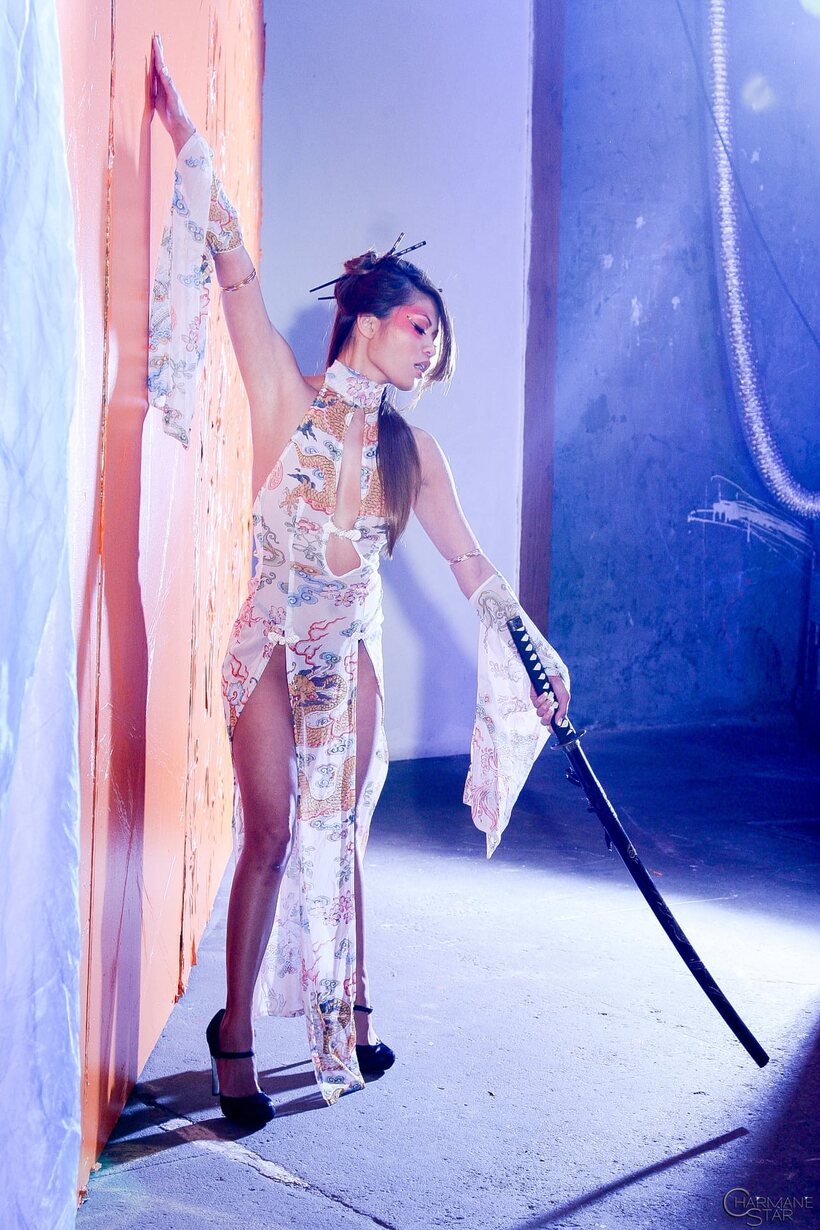 Image 1/15: Charmane Star strips to heels while posing with a sword
