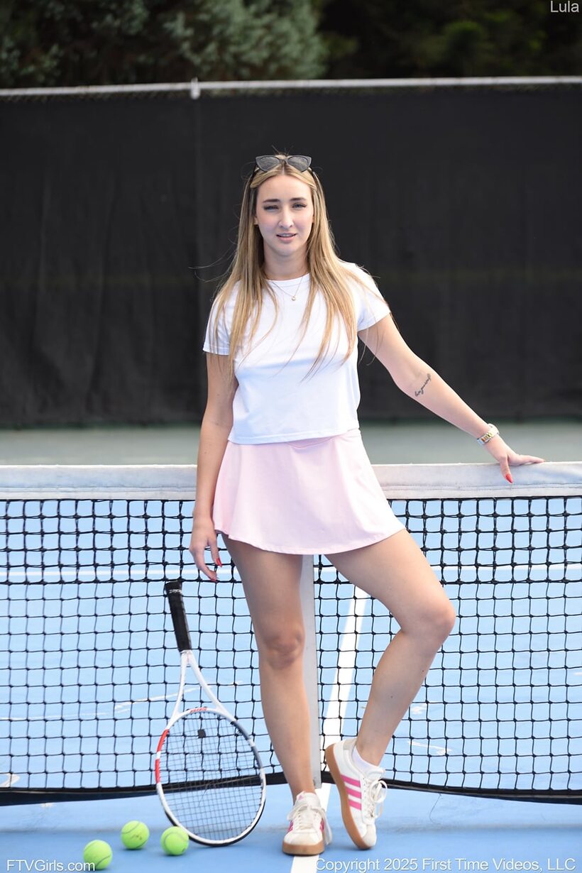 Photo 5 — Blonde amateur Lula Stocch serves tennis then poses in black fetish gear