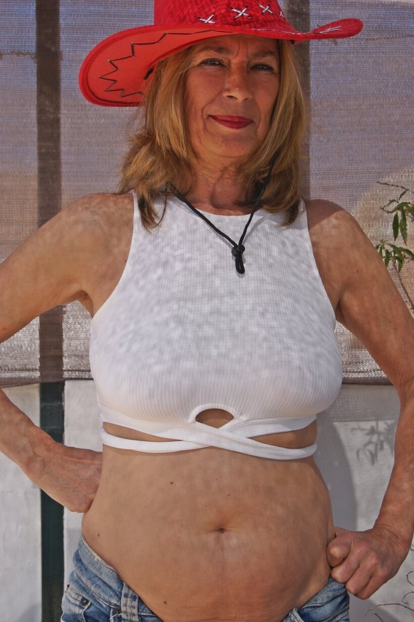 Clothed Marta Style shows off her saggy tits in a skirt (shot 9)