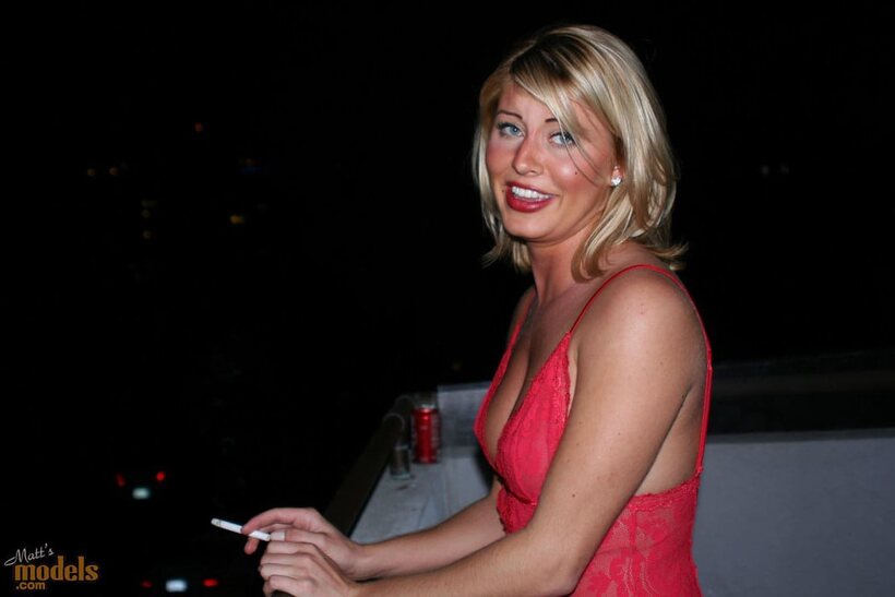 Lingerie-clad blonde with firm tits smokes naked on the balcony (shot 11)