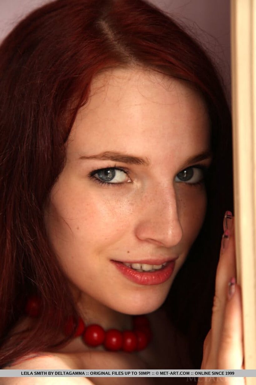 Leila Smith poses nude in a feather boa as a young redhead (shot 9)