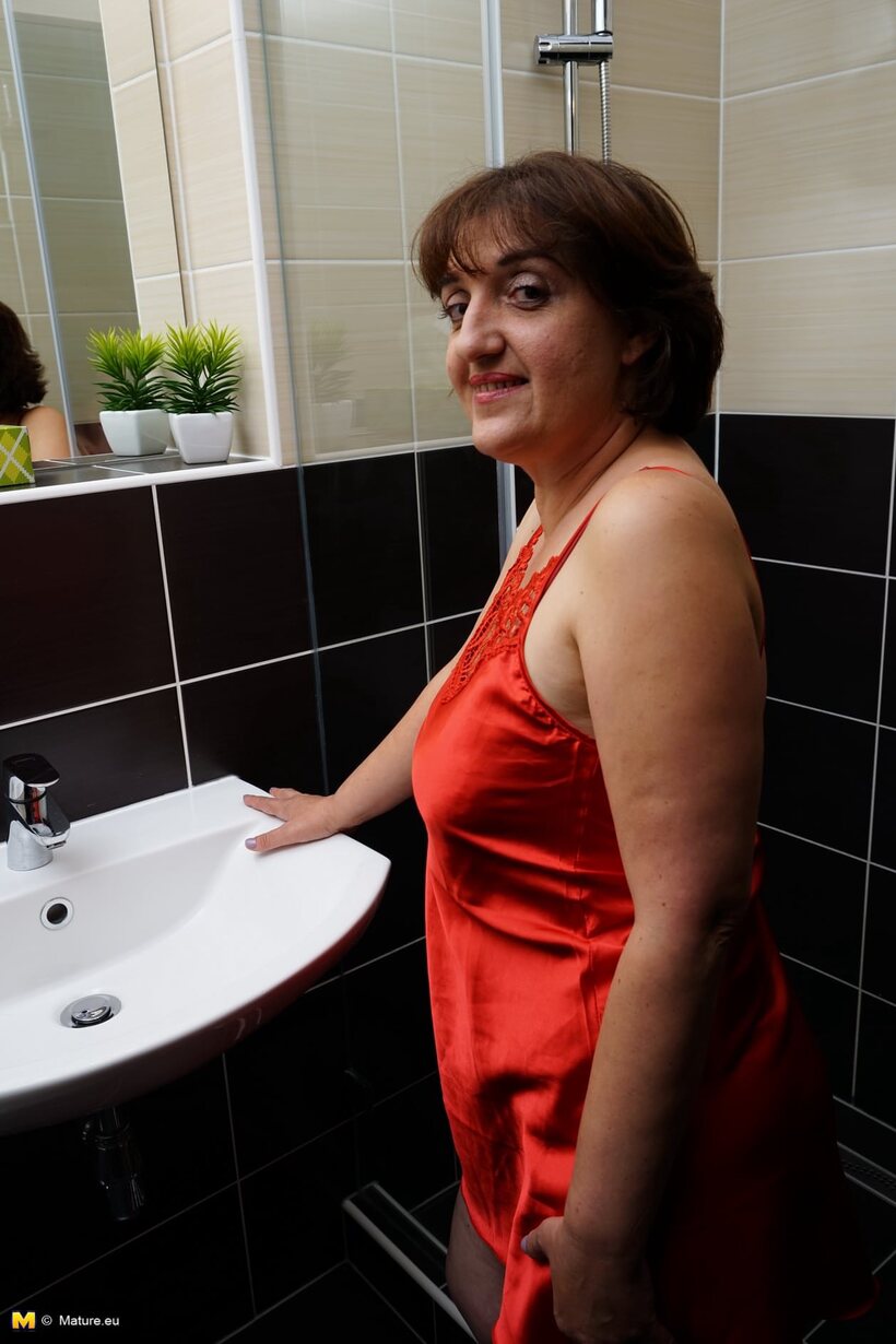 Ass nude photo 5 — Older woman strips off her red dress before stepping into the shower