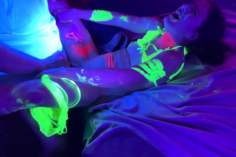 Photo 12 — Vanessa Cliff takes part in a glow-lit gangbang party