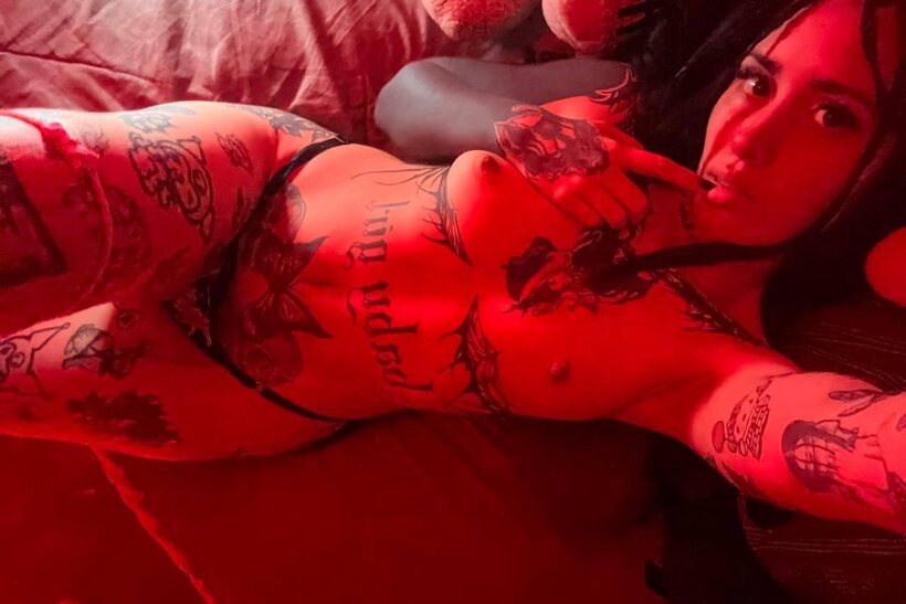 Tattooed teen poses for selfies with her tits out in a thong (shot 14)