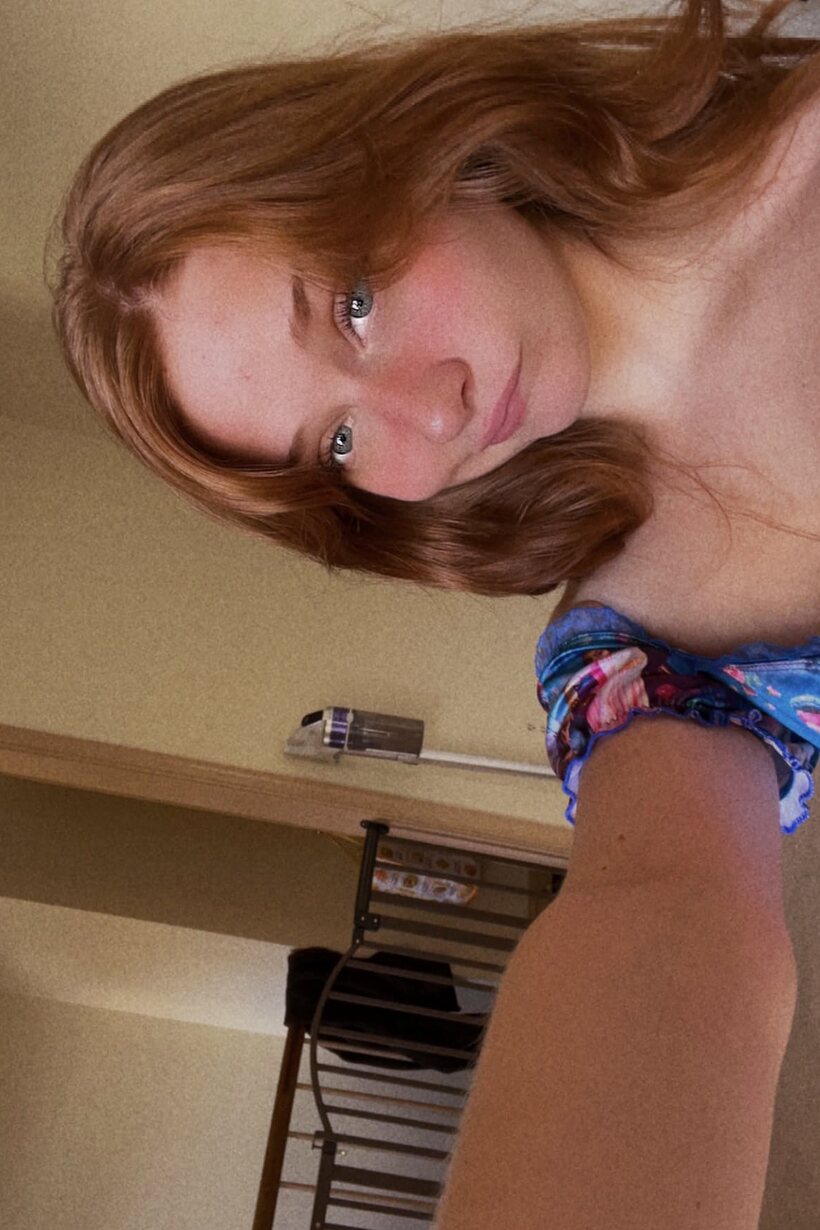 Photo 10 — Redhead snaps selfies while slipping into a crotchless dress