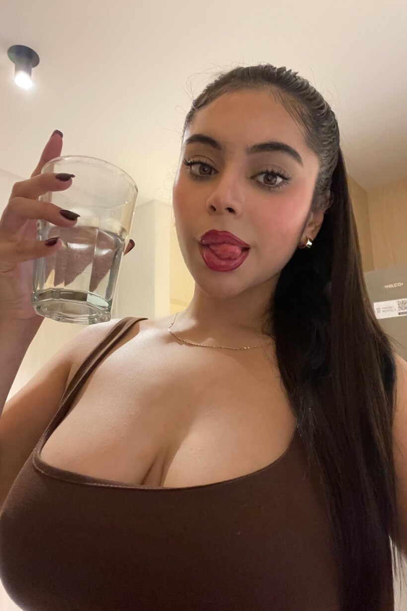 Photo 14 — Long-haired amateur takes selfies while flashing her big boobs