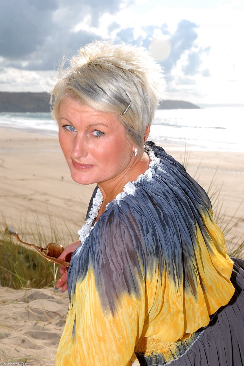 Image 3/20: Sally T shows her pierced pussy and tiny nipples in a beach dress
