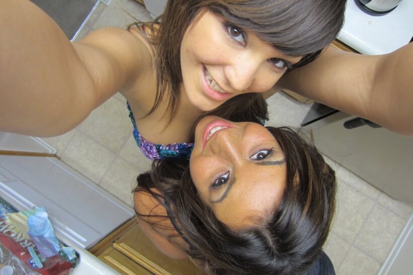 African pic 5 from the set «In bed, dark-haired beauties cuddle and kiss wearing shorts»