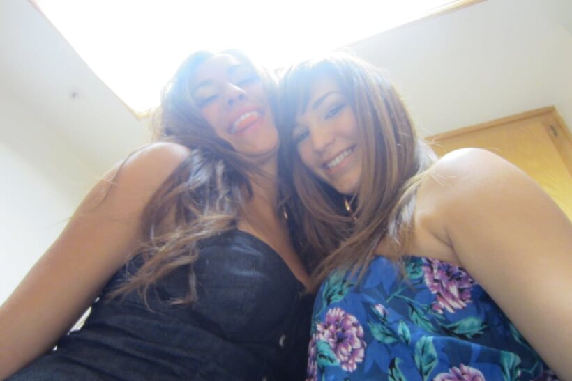 Image 6/14: In bed, dark-haired beauties cuddle and kiss wearing shorts