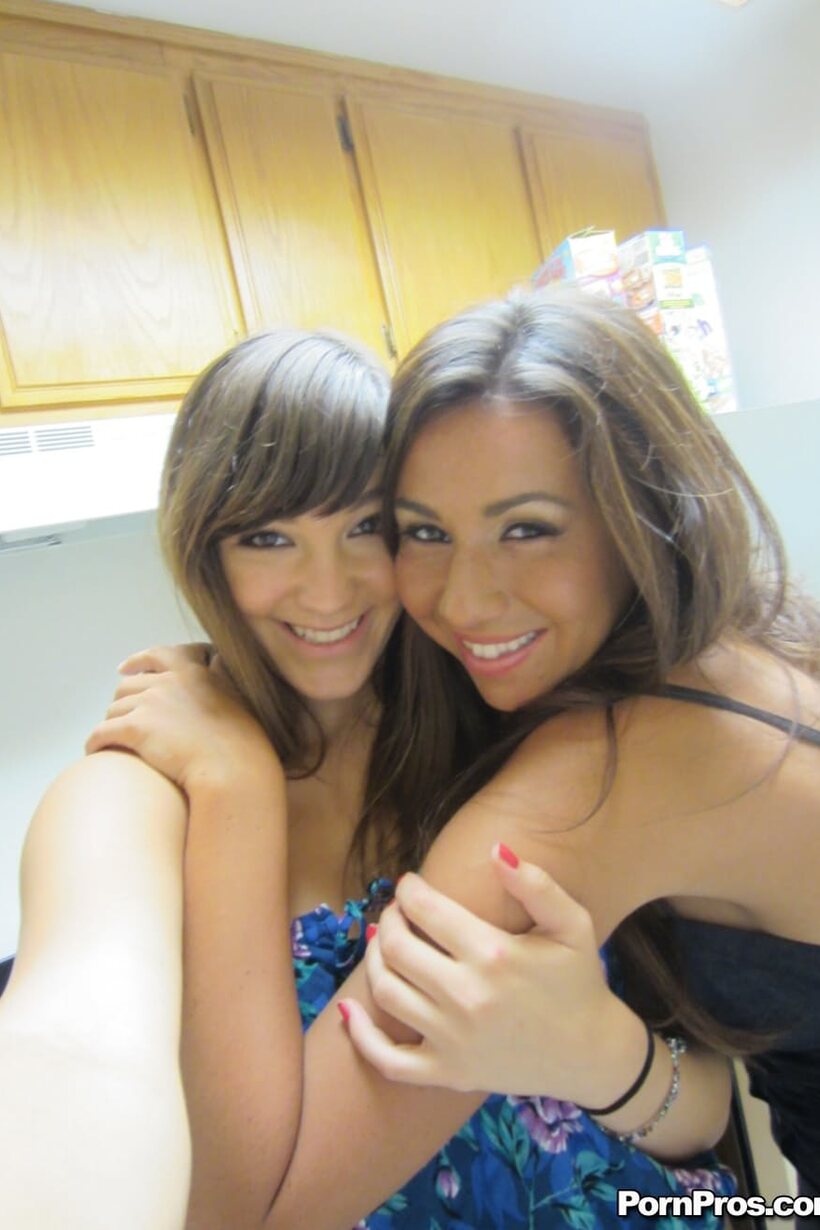 In bed, dark-haired beauties cuddle and kiss wearing shorts, photo 7 of 14