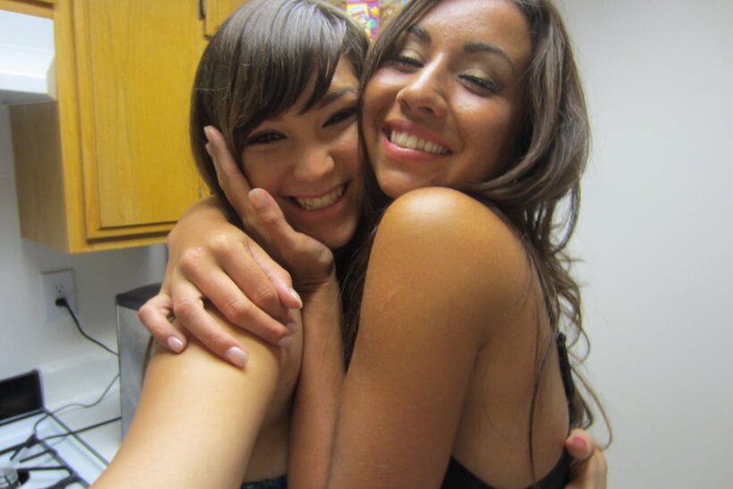 Photo 9 — In bed, dark-haired beauties cuddle and kiss wearing shorts
