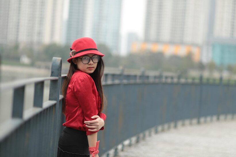Image 3/21: Natalia poses in a classy outfit on the bridge, Asian solo