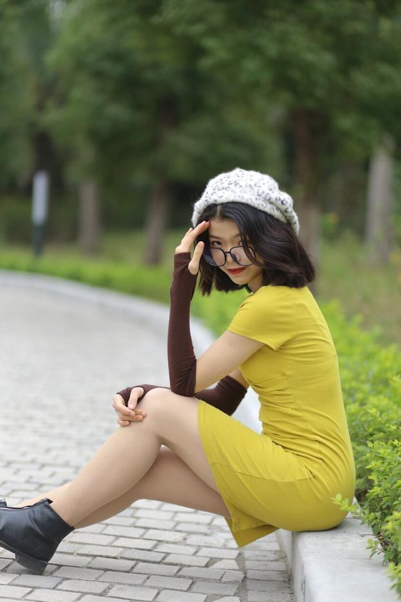 Irena poses in a yellow dress and glasses, looking shy (shot 19)