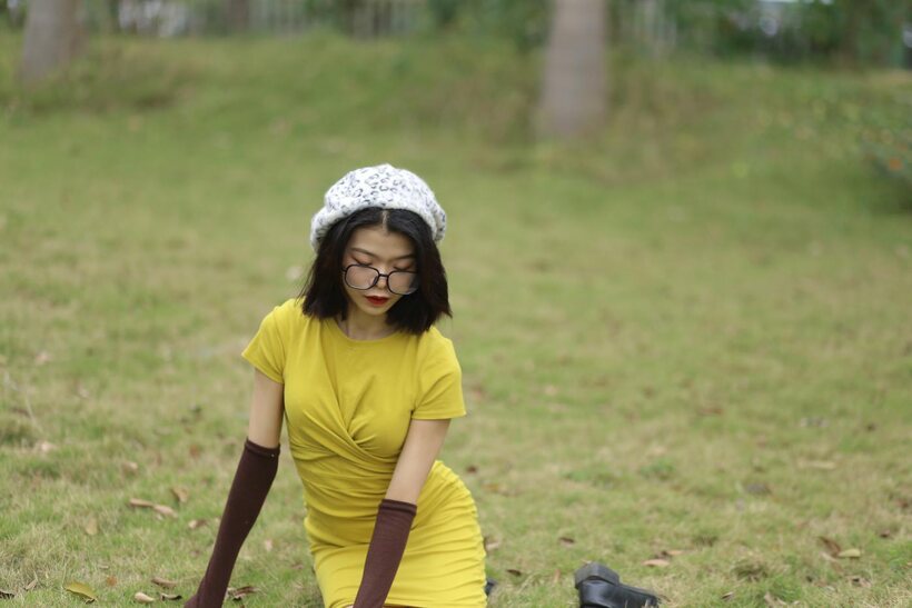 Irena poses in a yellow dress and glasses, looking shy, photo 21 of 21