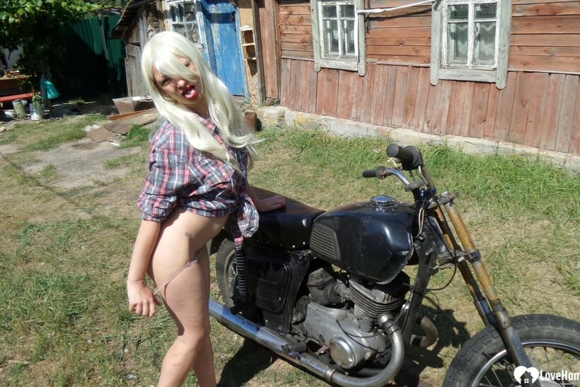 Amateur pic 7 from the set «Blonde American poses on a motorbike, then strips to flash her booty»