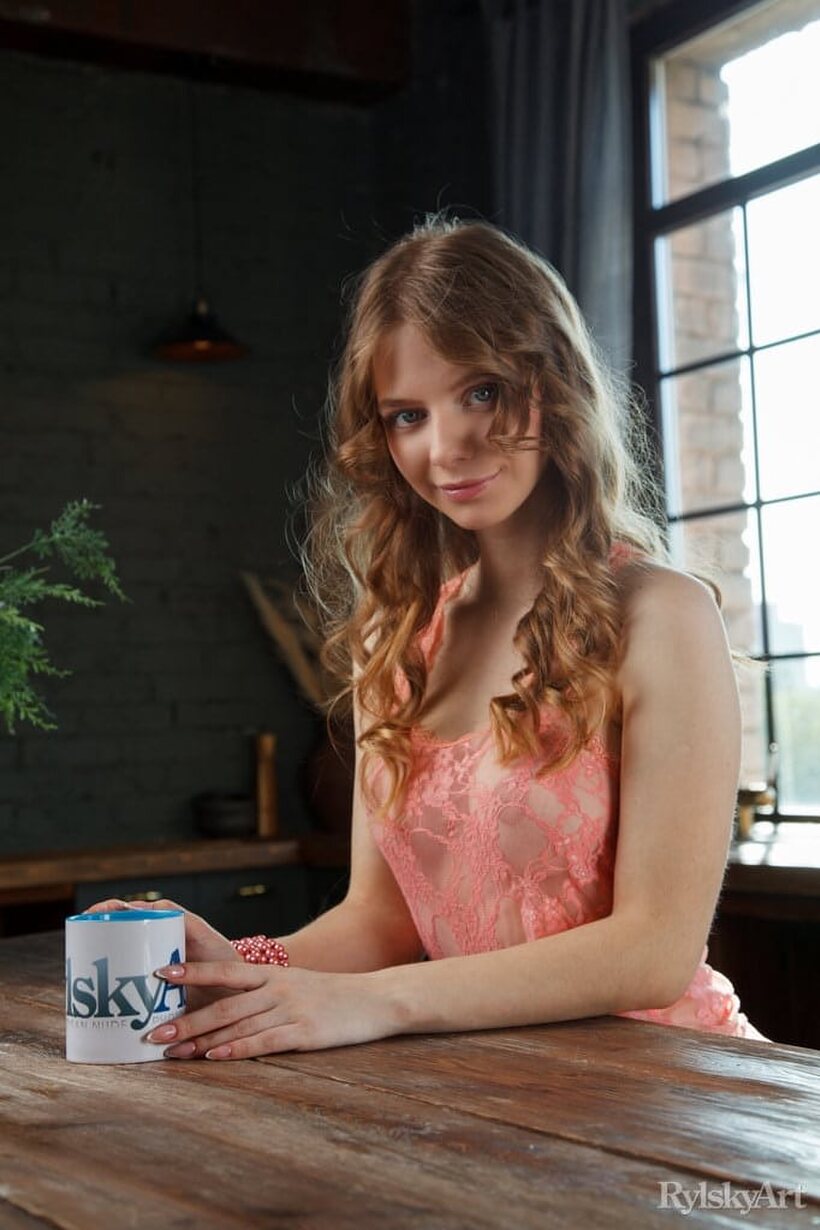 Naked on the kitchen table, Siya poses beside a cup of coffee (shot 5)