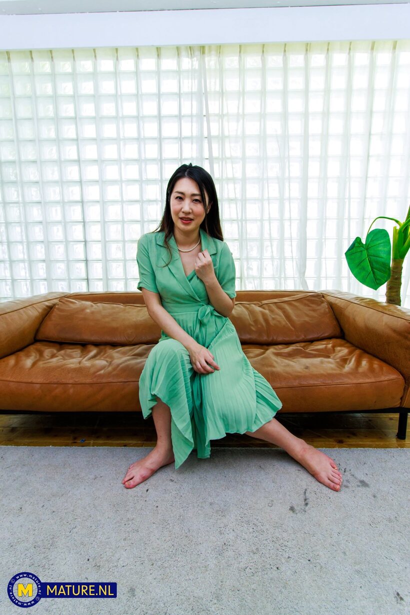Photo 4 — MILF Megumi Satuki in a dress shows her natural tits and hairy pussy on the sofa
