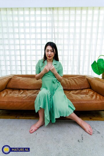 MILF Megumi Satuki in a dress shows her natural tits and hairy pussy on the sofa