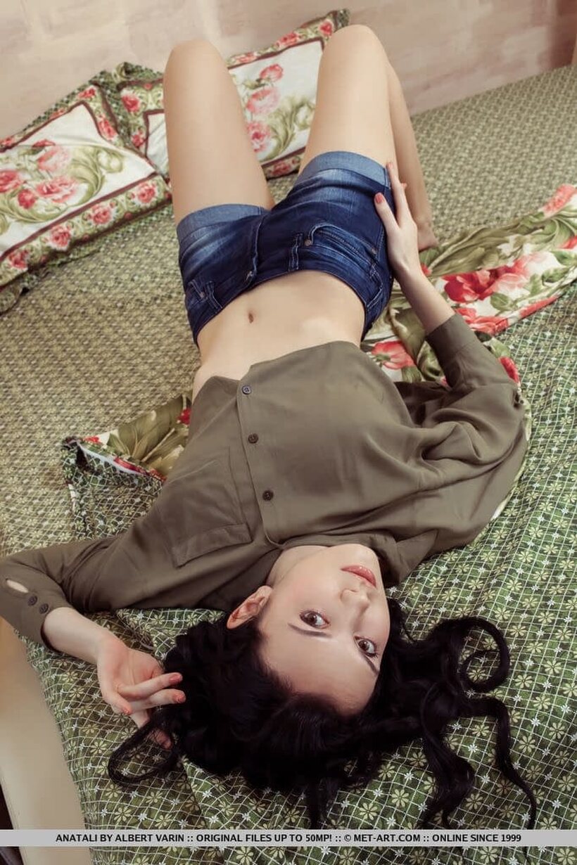 Babe nude photo 1 — Lying on her bed, dark-haired Anatali slips out of her clothes and bares her pussy