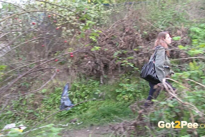 Denisa spreads her legs and pisses along a dirt path (shot 1)