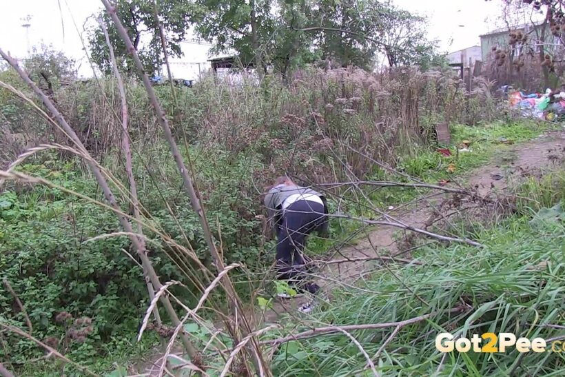 Denisa spreads her legs and pisses along a dirt path (shot 3)