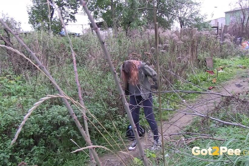 Image 13/15: Denisa spreads her legs and pisses along a dirt path