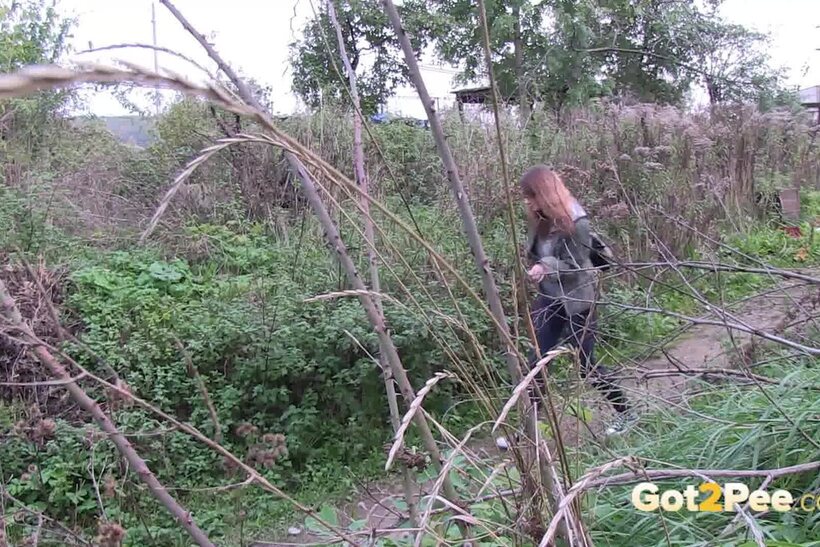 Photo 15 — Denisa spreads her legs and pisses along a dirt path