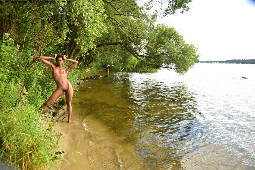 By the river, a short-haired ebony beauty shows off her toned ass (shot 12)