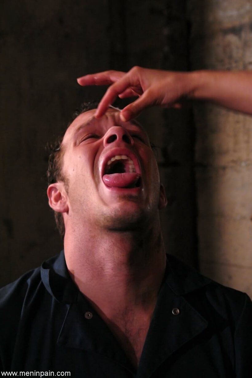 Isis Love has a male slave obey her inside a dungeon (shot 19)