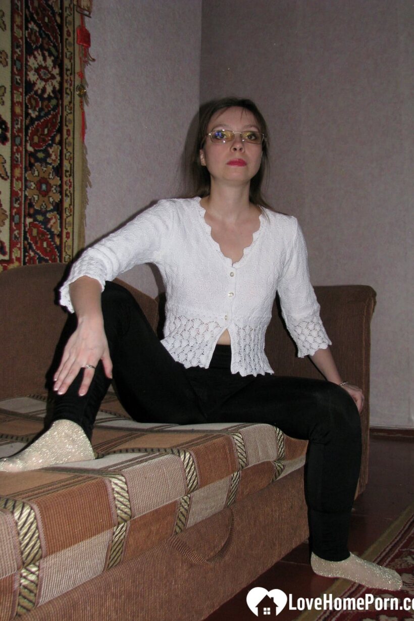 Amateur nude photo 1 — Stripping to her socks, dark-haired MILF shows off her hairy pussy