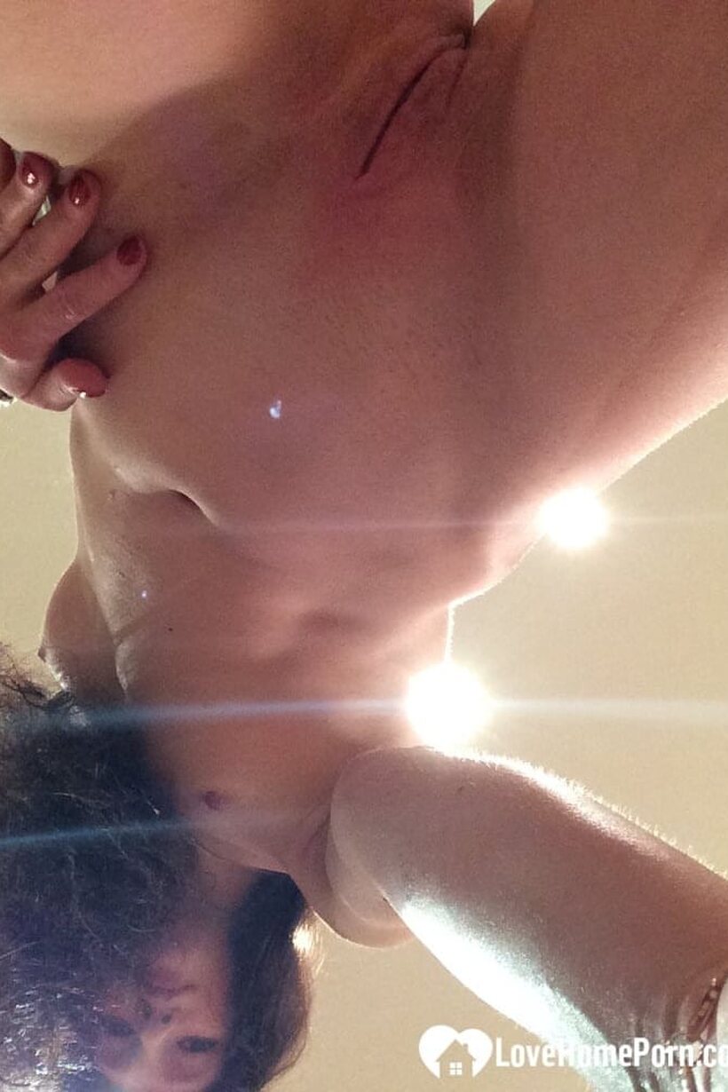 Taking nude selfies, a petite teen flashes tiny tits and shaved pussy (shot 3)