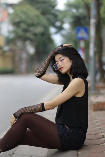 Asian girl exposes her body outdoors