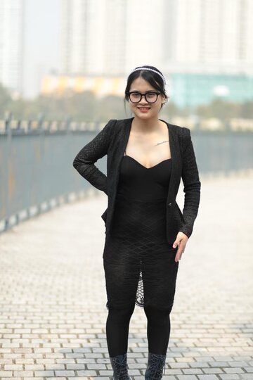 Posing outdoors in a hot black outfit, curvy Asian girl with glasses