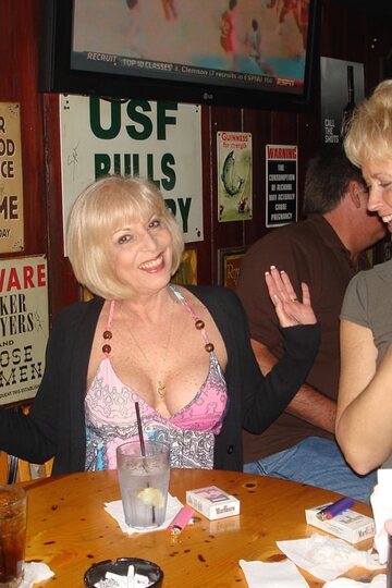 Mature Dee Delmar plays with a dildo and shows her big tits at a party with Tracy Lick