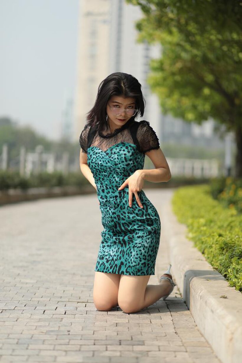 Photo 4 — Clothed girl flaunts her legs while flashing in public