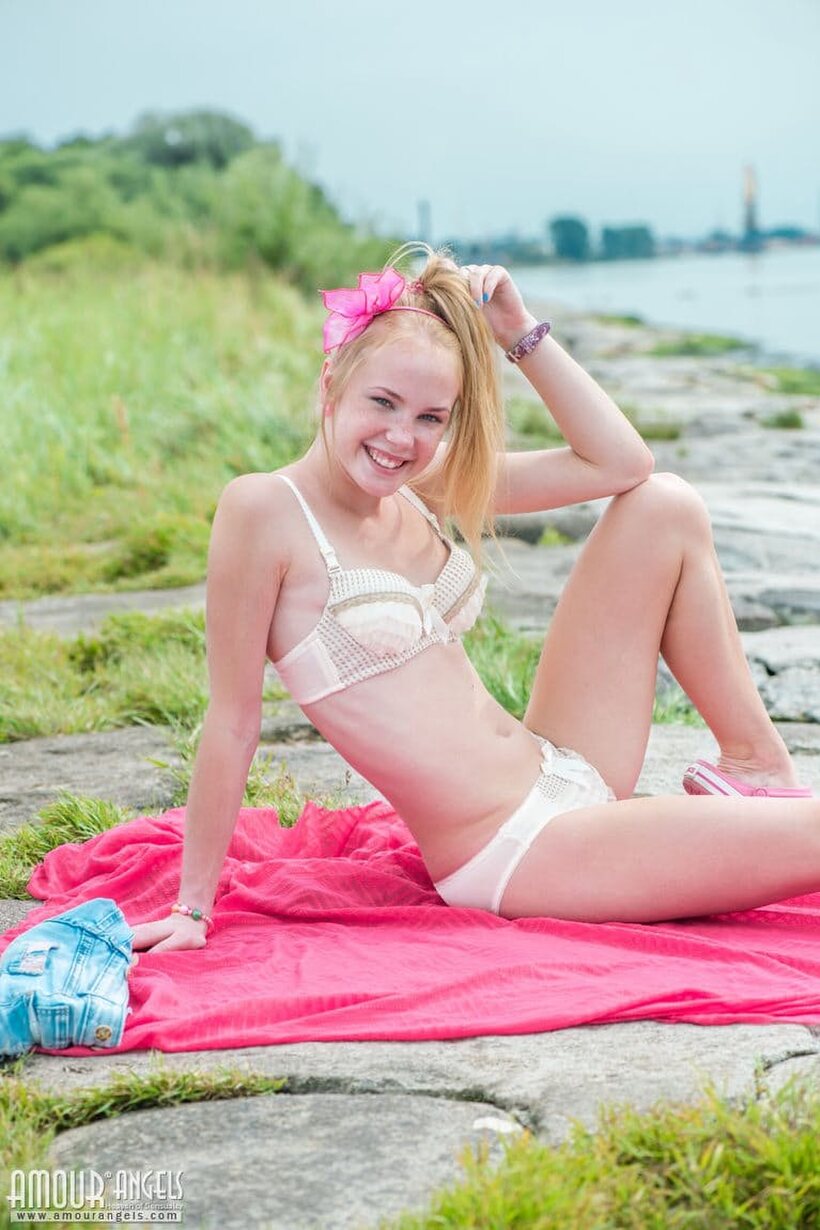 Photo 7 — Outdoors, Runa strips off her shorts and kneels down nude