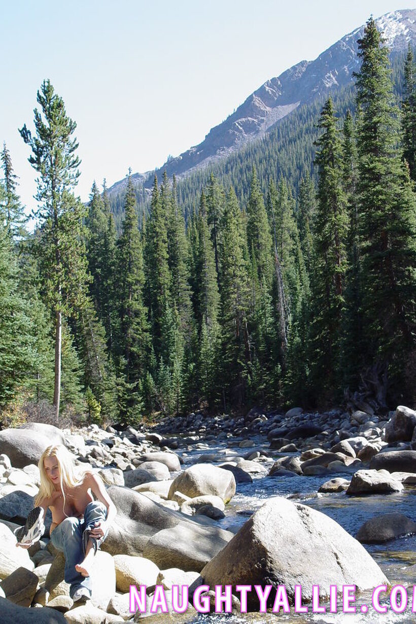 Naughty Allie strips naked on a boulder in the stream, blonde MILF style, photo 4 of 20