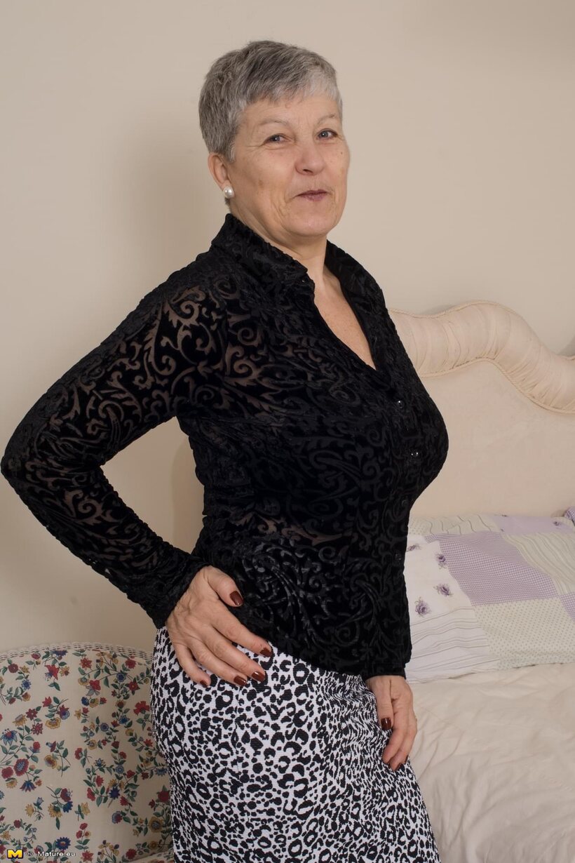 Photo 1 — Mature girl flaunts her big tits and ass while undressing
