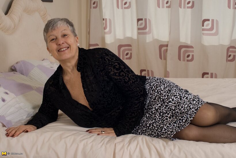 Photo 8 — Mature girl flaunts her big tits and ass while undressing