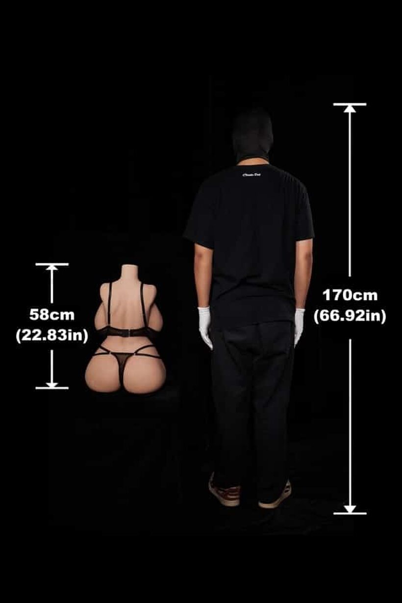 Photo 3 — In a dark room, a fully clothed man cradles a naked sex doll