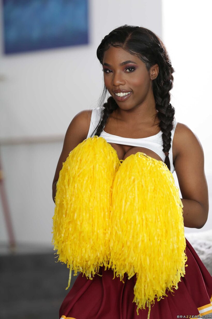 Image 7/20: Sarah Banks strips down as an ebony cheerleader, showing off her big tits and pussy