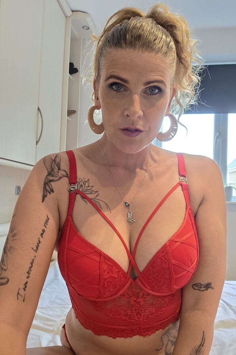 Image 6/10: Red lingerie and a pierced lip frame this tattooed BBW solo scene