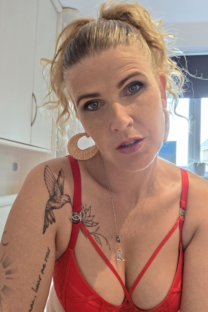 Red lingerie and a pierced lip frame this tattooed BBW solo scene (shot 9)