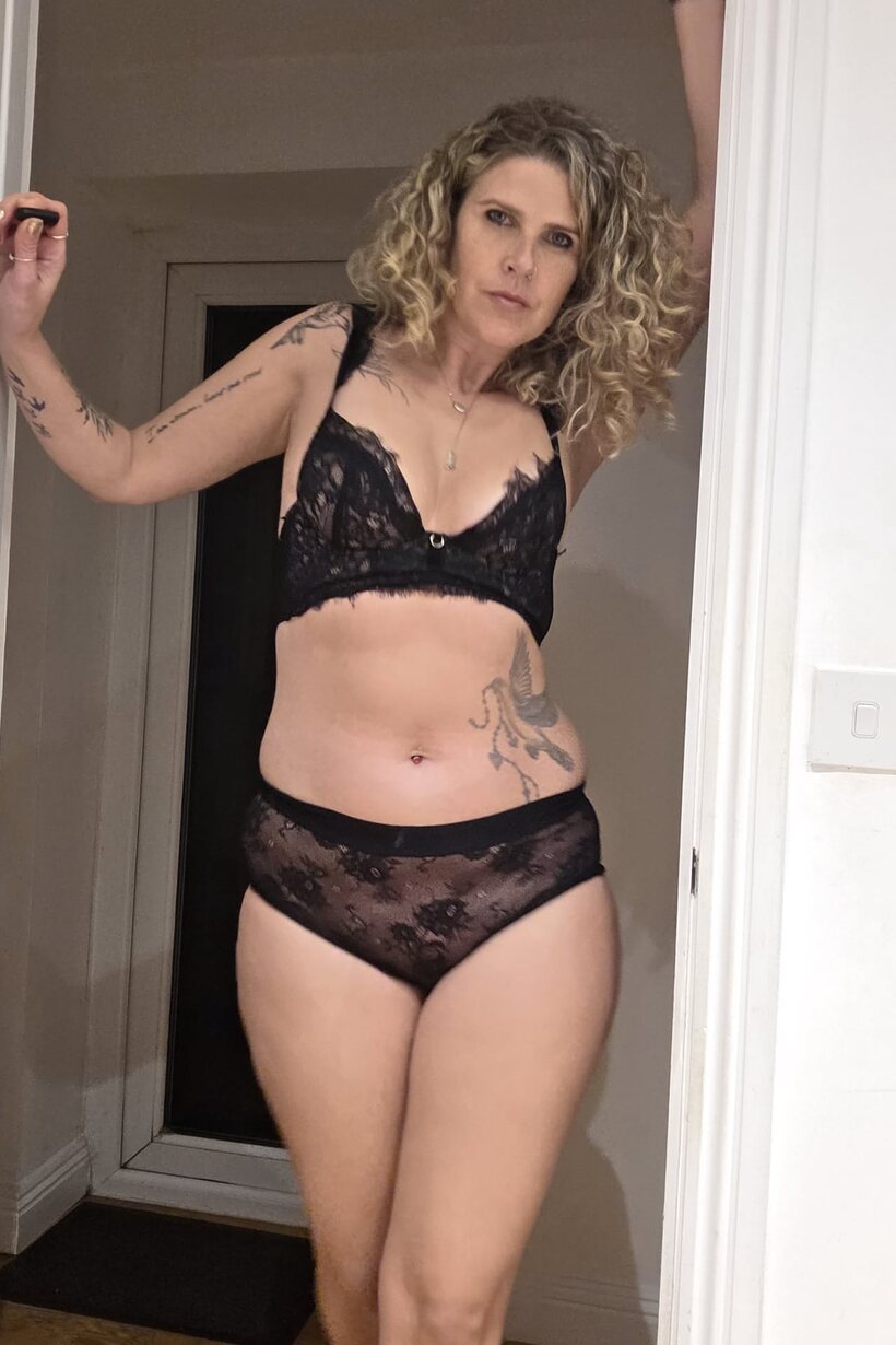 Black lingerie frames her thick body as she masturbates solo, photo 5 of 10