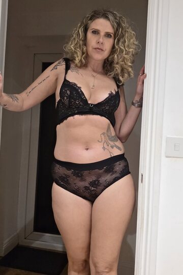 Black lingerie frames her thick body as she masturbates solo