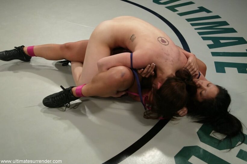 Image 10/20: Christina Aguchi and Devi Lynne kneel down for a lesbian wrestling scene
