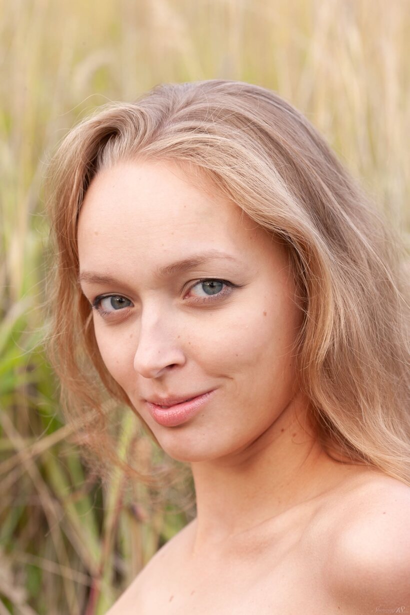Photo 21 — European girl shows off her tiny tits and tan lines outdoors