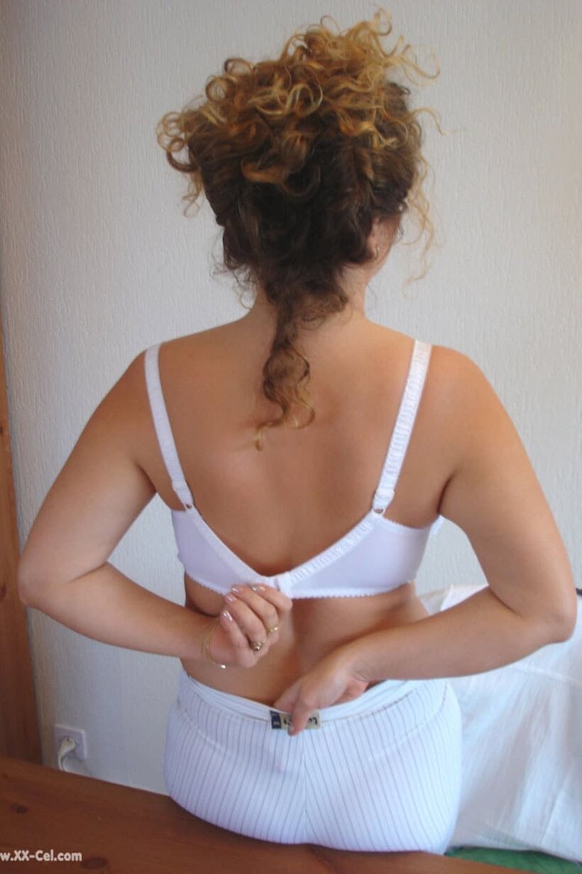 Angel Crisa strips off her blouse and bra, then cups her huge tits (shot 6)